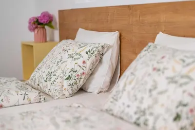 a bed with two pillows on top of it at Studio Maria with Free Parking in Bohinj