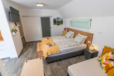 a small bedroom with a bed and a table at Studio Maria with Free Parking in Bohinj