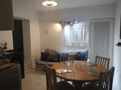 a living room with a wooden table and a couch at apartma Lesnik Vila Ziba in Bohinj