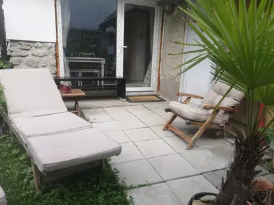 a pair of chairs and a chair on a patio at apartma Lesnik Vila Ziba in Bohinj