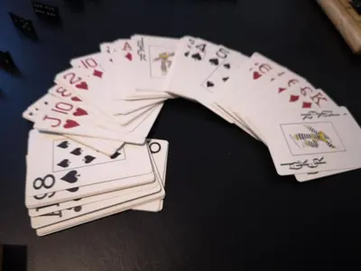 a pile of playing cards sitting on top of a table at Apartma Oreh Vila Ziba in Bohinj