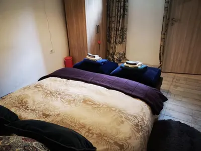 a bedroom with a bed with blue pillows on it at Apartma Oreh Vila Ziba in Bohinj