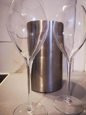 two wine glasses sitting on top of a table at Apartma Oreh Vila Ziba in Bohinj