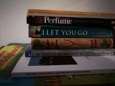 a stack of books stacked on top of each other at Apartma Oreh Vila Ziba in Bohinj