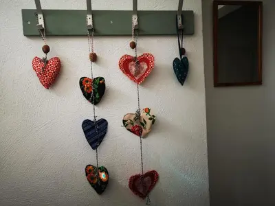 a bunch of hearts hanging on a wall at Apartma Oreh Vila Ziba in Bohinj