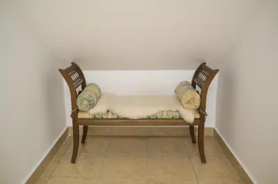 a dog sleeping on a chair in a room at Hiša Perla in Boštanj