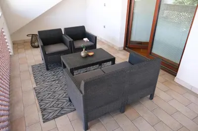 a living room with two chairs and a table at Hiša Perla in Boštanj