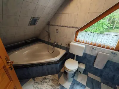 a bathroom with a toilet and a bath tub at Room Janez in Preddvor