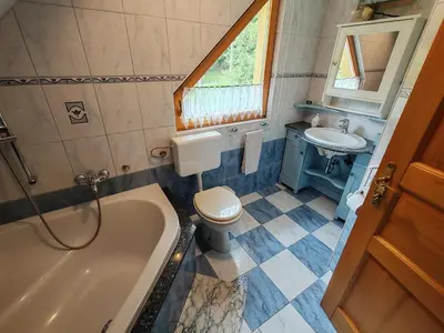 a bathroom with a tub and a toilet and a sink at Room Janez in Preddvor