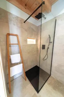 a shower with a glass door in a bathroom at Glamping Zarja, Vipava Valley in Zoll