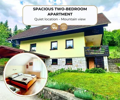 a round mirror in front of a house at Aparthouse Bohinj in Bohinj