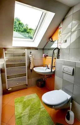 a bathroom with a sink and a toilet and a window at Aparthouse Bohinj in Bohinj