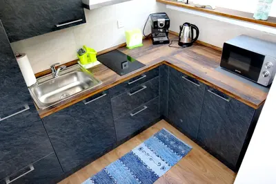 a small kitchen with a sink and a microwave at Aparthouse Bohinj in Bohinj