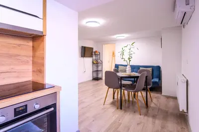 a kitchen and a dining room with a table and chairs at The Darling Loft in Ljubljana