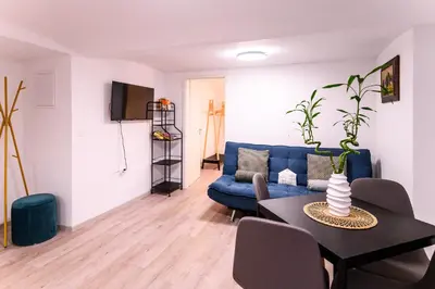 a living room with a blue couch and a table at The Darling Loft in Ljubljana