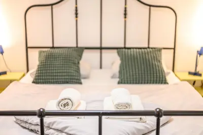 a bedroom with a bed with towels on it at The Darling Loft in Ljubljana