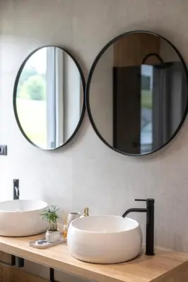 a bathroom with two sinks and a large mirror at Midnight Villa in Cerkvenjak