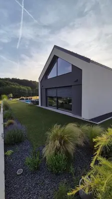 a house with a large window on the side of it at Midnight Villa in Cerkvenjak
