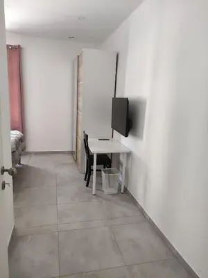 a room with a table and a tv on a wall at Apoteka in Lenart v Slovenskih Goricah