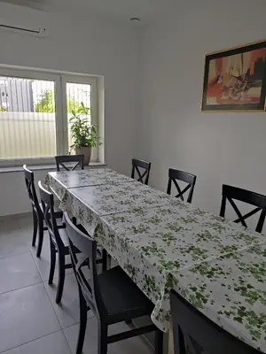 a dining room table with chairs and a green and white table cloth at Apoteka in Lenart v Slovenskih Goricah