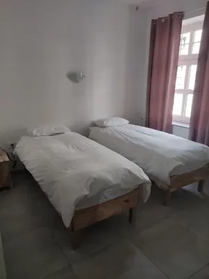 two beds sitting next to each other in a bedroom at Apoteka in Lenart v Slovenskih Goricah