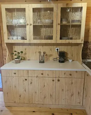 a kitchen with wooden cabinets and a counter top at Cottage Ladybug in Mojstrana