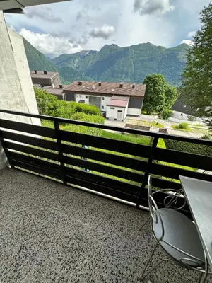 a balcony with a table and a view of mountains at Apartma Marjeta in Bovec