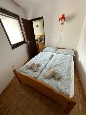 a bedroom with a bed with two pillows on it at Apartma Marjeta in Bovec