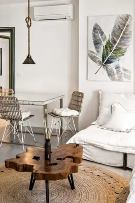 a living room with a coffee table and a bed at Apartments Mazijeva in Ljubljana