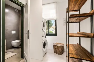 a laundry room with a washer and dryer at Apartments Mazijeva in Ljubljana