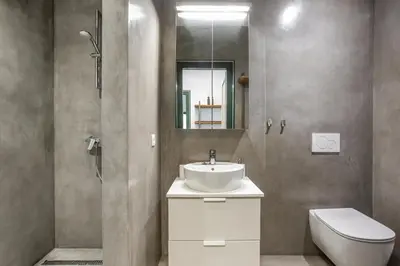 a bathroom with a sink and a toilet and a mirror at Apartments Mazijeva in Ljubljana
