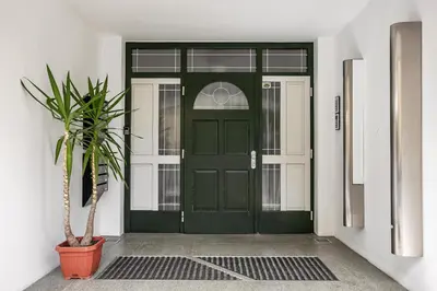 a green door with a potted plant in front of it at Apartments Mazijeva in Ljubljana
