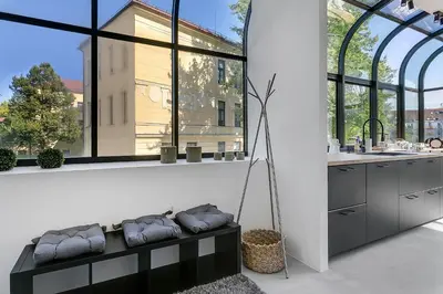 a kitchen with a black bench in front of a window at Apartments Mazijeva in Ljubljana