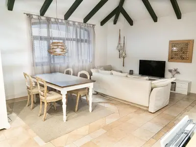 a living room with a table and a couch at Apartments Mazijeva in Ljubljana