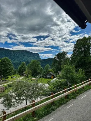 a road with a fence and a view of a field at Bijol Apartments in Bled