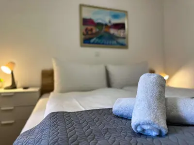 a bedroom with a bed with towels on it at Bijol Apartments in Bled