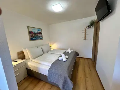 a small bedroom with a bed with towels on it at Bijol Apartments in Bled