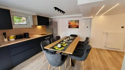 a kitchen and dining room with a table and chairs at Relax apartment Ljubljana in Ljubljana
