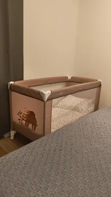 a bed with a crib with a monkey on it at Relax apartment Ljubljana in Ljubljana