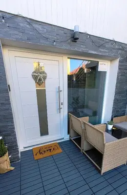 a white garage door with a table and chairs at Relax apartment Ljubljana in Ljubljana