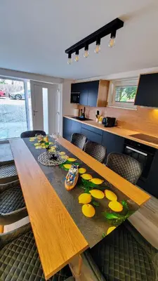 a wooden table with lemons on it in a kitchen at Relax apartment Ljubljana in Ljubljana