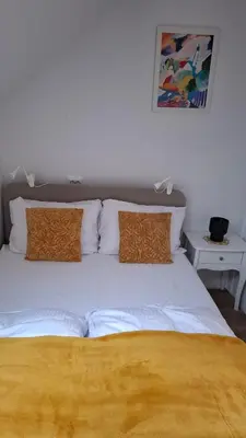 a white bed with two pillows on top of it at Apartma Harmonia with parking in Bled