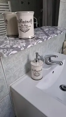 a bathroom sink with two buckets on top of it at Apartma Harmonia with parking in Bled