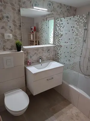 a bathroom with a toilet and a sink and a shower at RELAX HOUSE Kolpa view Podzemelj in Gradac