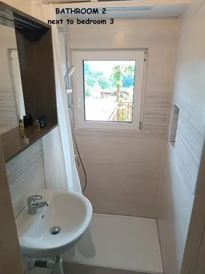 a bathroom with a sink and a window at RELAX HOUSE Kolpa view Podzemelj in Gradac