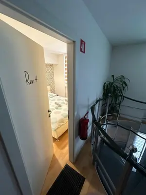 a room with a door leading to a bedroom at Granada Rooms in Ljubljana