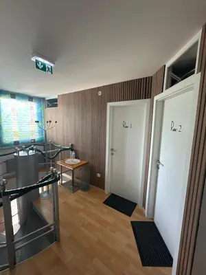 a room with two white doors and a table at Granada Rooms in Ljubljana