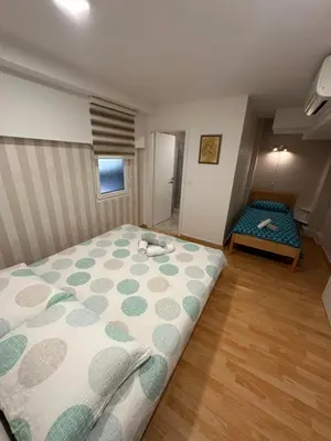a bedroom with a bed and a bench in it at Granada Rooms in Ljubljana