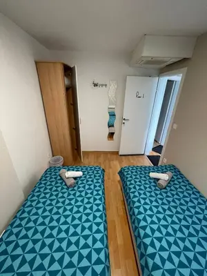 a room with two beds in a room at Granada Rooms in Ljubljana