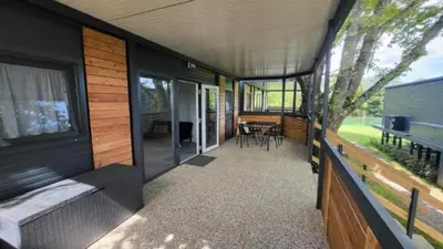 a screened in porch of a house with a bedroom at BIG BERRY KOLPA - KIWI mobile house, Metlika in Gradac
